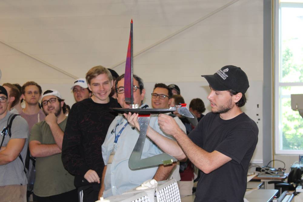 Student with his boat for the competition